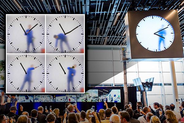 A Man Paints Minutes of a Clock by Hand